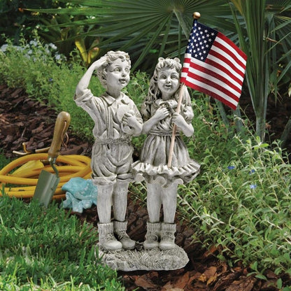 ALDO Décor>Artwork>Sculptures & Statues 8"Wx4.5"Dx16"H / NEW / rasin Patriotic USA Flag Holding Children Celebrating the 4th of July Garden Statue by artist Evelyn Myers Hartley